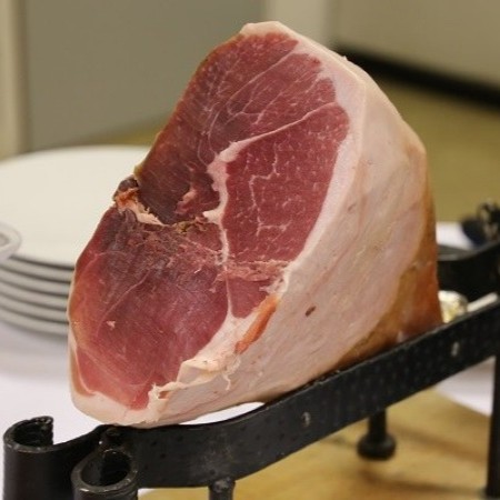 Primo piano di una coscia di prosciutto su supporto da taglio per l’affettamento a coltello (Fonte Fabrizio Dell’Aquila)